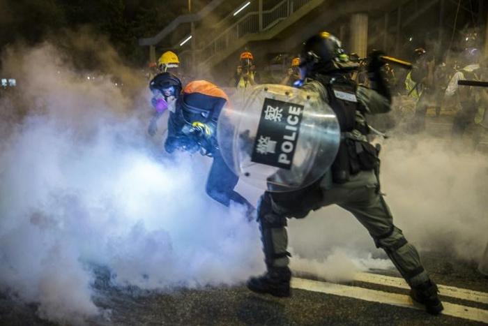 Police charge protesters in the shopping district of Causeway Bay in Hong Kong
