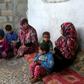 Angham Zorab (L) sits with family members at their modest home in the southern Gaza Strip refugee camp of Khan Yunis