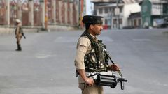 Tens of thousands of extra Indian troops enforced a blanket curfew on top of a total communications blackout in India-administered Kashmir