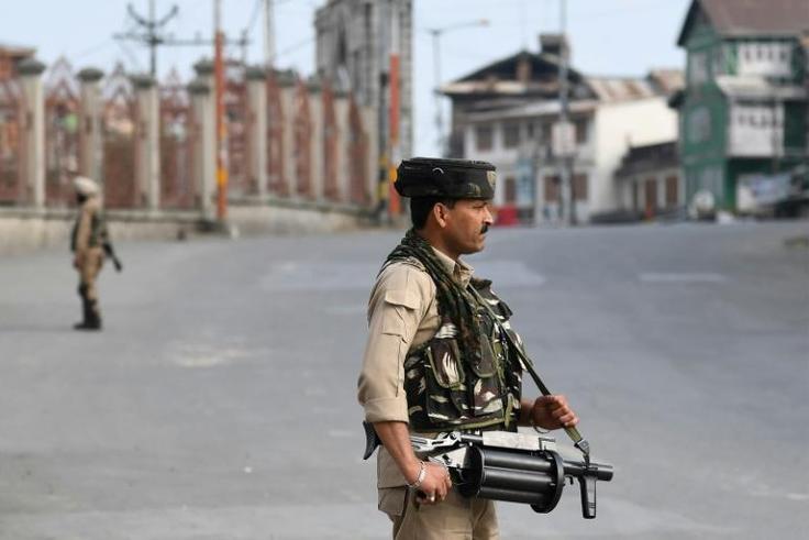 Tens of thousands of extra Indian troops enforced a blanket curfew on top of a total communications blackout in India-administered Kashmir