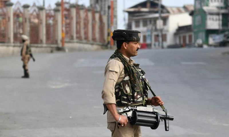Tens of thousands of extra Indian troops enforced a blanket curfew on top of a total communications blackout in India-administered Kashmir