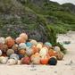 A pile of collected fishing bouys on a beach on Henderson Island, an uninhabited part of the Pitcairn archipelago in the South Pacific Ocean
