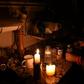 A woman prepares milk bottles by candle lights at her home in Montevideo during a massive power failure
