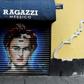In this file picture taken on August 30, 2017 a woman walks past a mural of Mexican artist Frida Kahlo at Mesones street in Mexico City