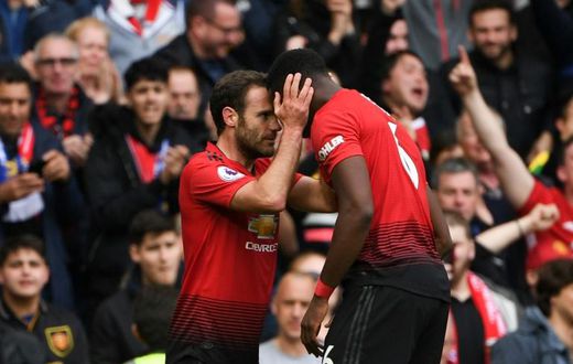 Positive Pogba: Juan Mata (left) believes Paul Pogba (right) remains a positive influence for Manchester United