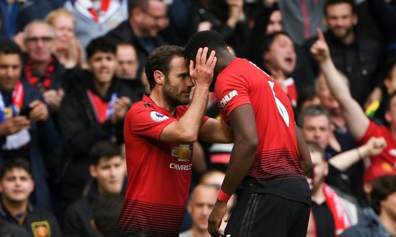 Positive Pogba: Juan Mata (left) believes Paul Pogba (right) remains a positive influence for Manchester United