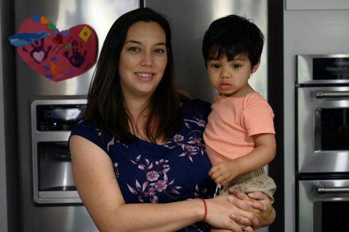 Cindy Luna holds her son Mateo, born via in-vitro fertilization in 2017, at the family's Virginia home
