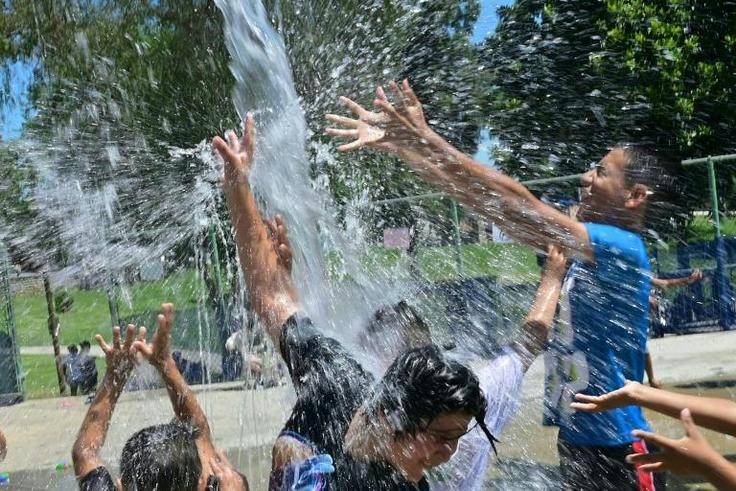 Children cool off at a water park in Alhambra, California on July 27, 2019
