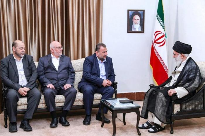 Iran's supreme leader Ayatollah Ali Khamenei (R) meets a Hamas delegation in Tehran, in a picture released by his office