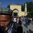 Uighur men dance after Eid al-Fitr prayers, marking the end of Ramadan, at the Id Kah mosque in Kashgar