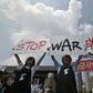 Anti-war activists hold placards reading "Stop War Exercises" during a rally against planned South Korea-US annual joint military exercises near the US embassy in Seoul on August 5, 2019