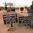 A Sudanese mother, Khadom, mourns at the grave of her son Al-Moez, who was killed when a bullet pierced the window of his workplace during anti-government demonstrations in April