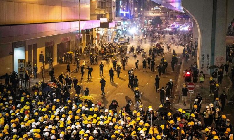 Tear gas filled Hong Kong's commercial district on Sunday