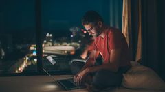 Man working in the bedroom at night