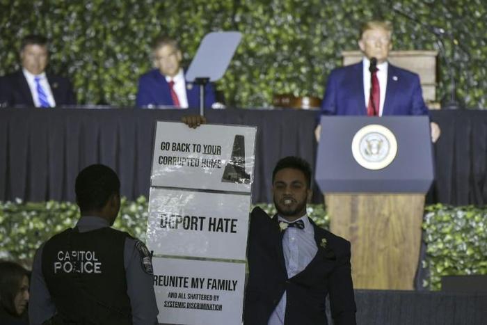 Ibraheem Samirah, a Democratic Virginia assemblyman, protests during US President Donald Trump's speech