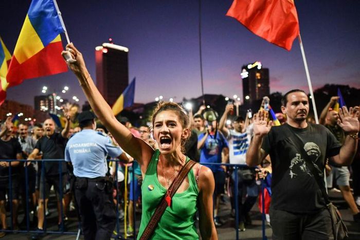 An estimated 24,000 protesters gathered in front of the government's headquarters in Bucharest, waving the national flag and shouting  "Thieves!"