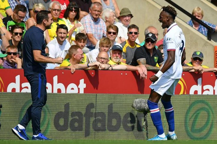 Chelsea striker Tammy Abraham runs to celebrate with boss Frank Lampard