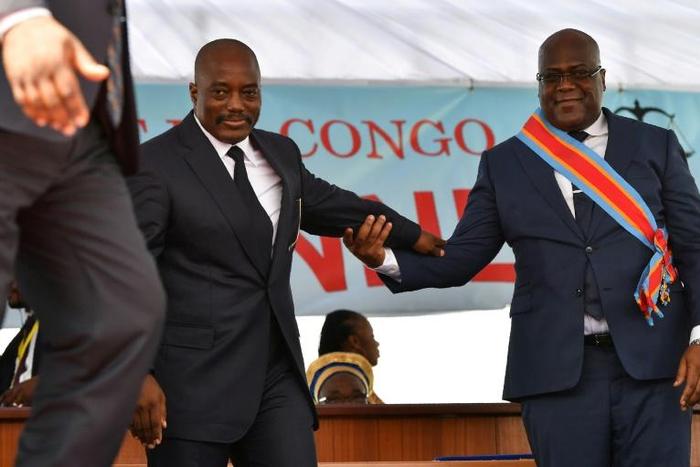 During his inauguration DR Congo's new president, Felix Tshisekedi, (R) walks off the podium with outgoing leader Joseph Kabila in Kinshasa in January 2019