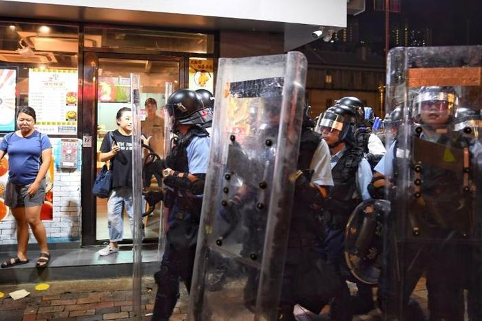 Hong Kong police patrol on Wednesday, a day after pro-democracy protestors partially shut down the territory's airport
