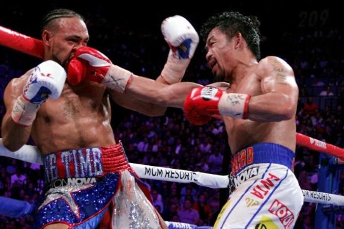 Filipino boxer Manny Pacquiao slams a right to the face of American Keith Thurman