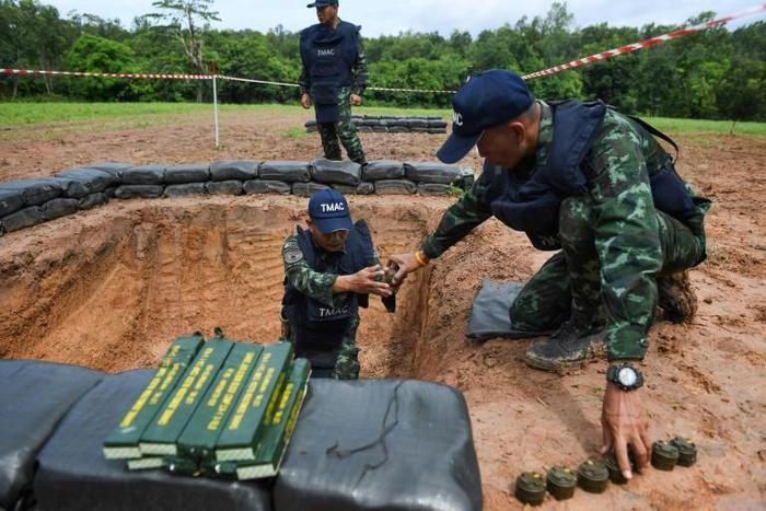 Soldiers carefully handled anti-personnel mines and C4 explosives before their controlled detonation
