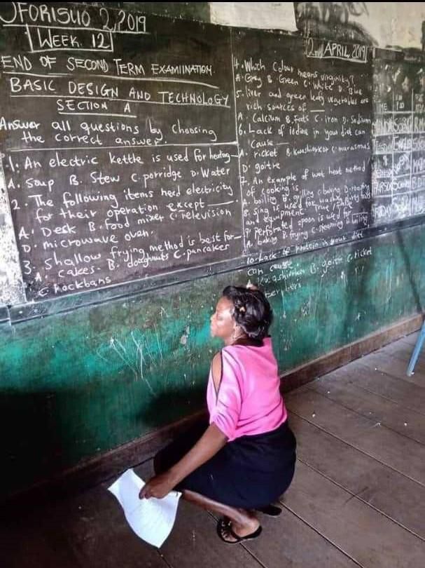 Teachers write exam questions on chalkboards