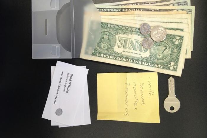 This undated image released by the publication Science, shows a clear wallet and its contents used in a study of how people in 40 countries decided to return, or not, “lost” wallets