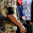 An Egyptian soldier speaks with a woman, as a youth behind her wears a t-shirt that reads "do the right thing", in Shubra on April 20, 2019; Egypt's parliament has approved amendments to a law that rights groups say imposes strict curbs on NGOs