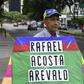 An opposition activist carries a kite with the name of recently deceased navy captain Rafael Acosta in Caracas: the US said it will impose snactions on the intelligence agency accused or torturing him to death