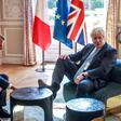 For one brief moment -- immortalised by photographers -- Johnson leant back in his chair and placed the sole of his right foot on a table as he sat down for talks with Macron