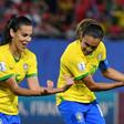 Marta (right) celebrates her record-breaking goal with midfielder Thaisa