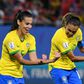 Marta (right) celebrates her record-breaking goal with midfielder Thaisa