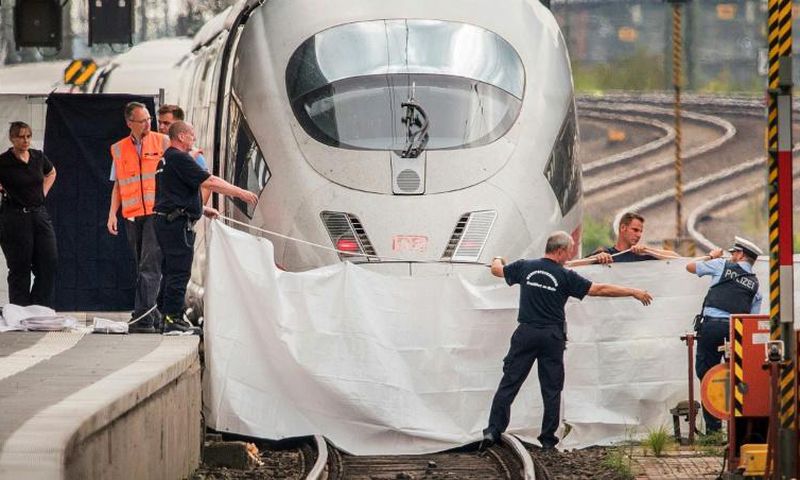An Eritrean man has been charged with murder and attempted murder for pushing a mother and her son in front of a train as it arrived in Frankfurt