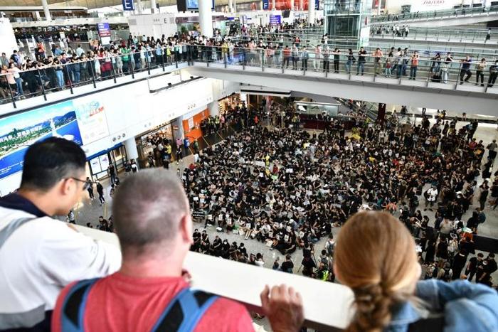 Hong Kong airport's arrival hall echoed with anti-government chants on Friday
