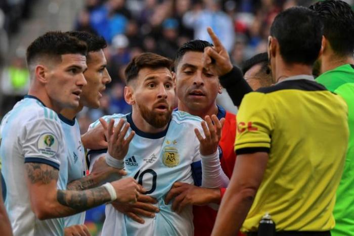 Argentina's Lionel Messi (C) talks to Paraguayan referee Mario Diaz de Vivar after he and Chile's Gary Medel were sent off during their Copa America football tournament third-place match in Sao Paulo, Brazil, on July 6, 2019