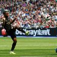 Manchester City's Raheem Sterling lifts the ball over Lukasz Fabianski to score their third goal at West Ham