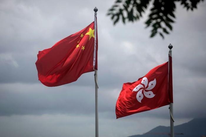 China's national flag is seen beside the Hong Kong ensign a day after protesters broke into the government headquarters in the city