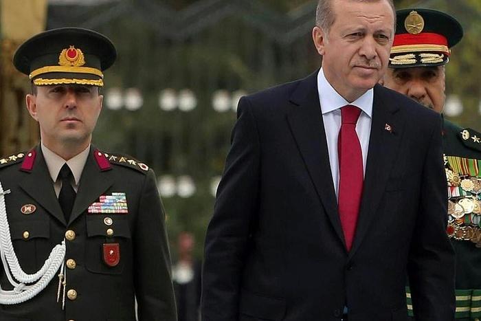 The court handed down an aggravated life sentence for "violating the constitution" to Colonel Ali Yazici (L), former military aide to Erdogan (R)