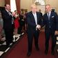 Cummings is pictured in jeans and a T-shirt, in the corner on the right, as Johnson entered Downing Street last week, shown shaking hands with Cabinet Secretary Mark Spencer