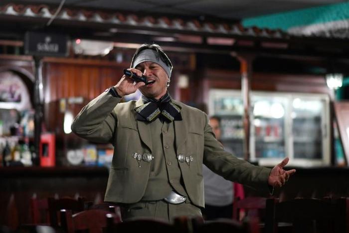 Venezuelan nurse Edgar Fernandez, who works at a state hospital, sings in mariachi costume at a restaurant at the town of El Junquito near Caracas