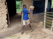 Pupils mould blocks with mud to construct classroom
