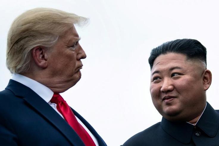 US President Donald Trump and North Korea's leader Kim Jong Un talk before a meeting in the Demilitarized Zone