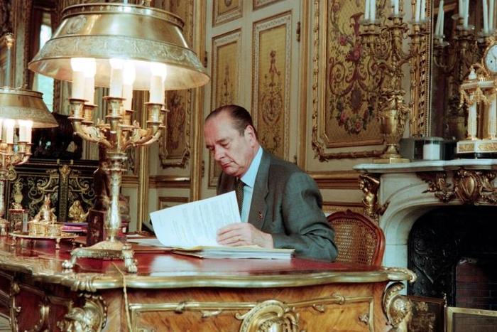 French President Jacques Chirac poses at his desk at the Elysee Palace in Paris in April 1996