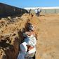 Municipality workers bury African migrants whose bodies were recovered near the eastern Tunisian coastal city of Zarzis