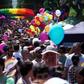 Men and women in colourful costumes, including several dressed as samba dancers, paraded through the streets on motorised floats or sashayed alongside