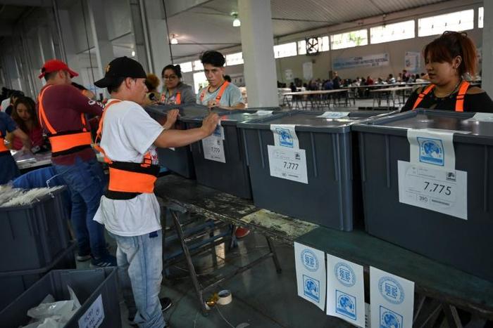 Employees of the Electoral Supreme Court arrange ballots in Guatemala City