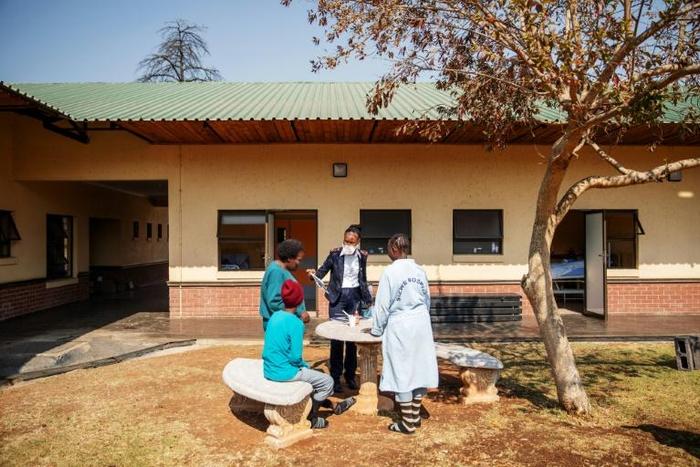 TB patients participate in painting activities with a caretaker in the garden of Ward 16, where the drug-resistant tuberculosis patients are housed and treated, on August 5, 2019, at the Sizwe Tropical Diseases Hospital in Johannesburg