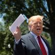 US President Donald Trump holds piece of paper saying it's his deal with Mexico as he speaks with reporters at the White House