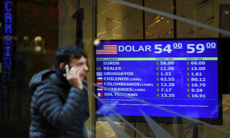 Currency exchange values are displayed on the buy-sell board in Buenos Aires, on August 13, 2019