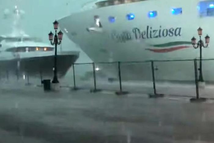 This photo grabbed from a video taken on July 7, 2019 and obtained on July 8, 2019 from Roberto Ferrucci (www.robertoferrucci.com) shows the 292-meter-long Costa Deliziosa cruise ship (right) close to a yacht (left) as it left Venice